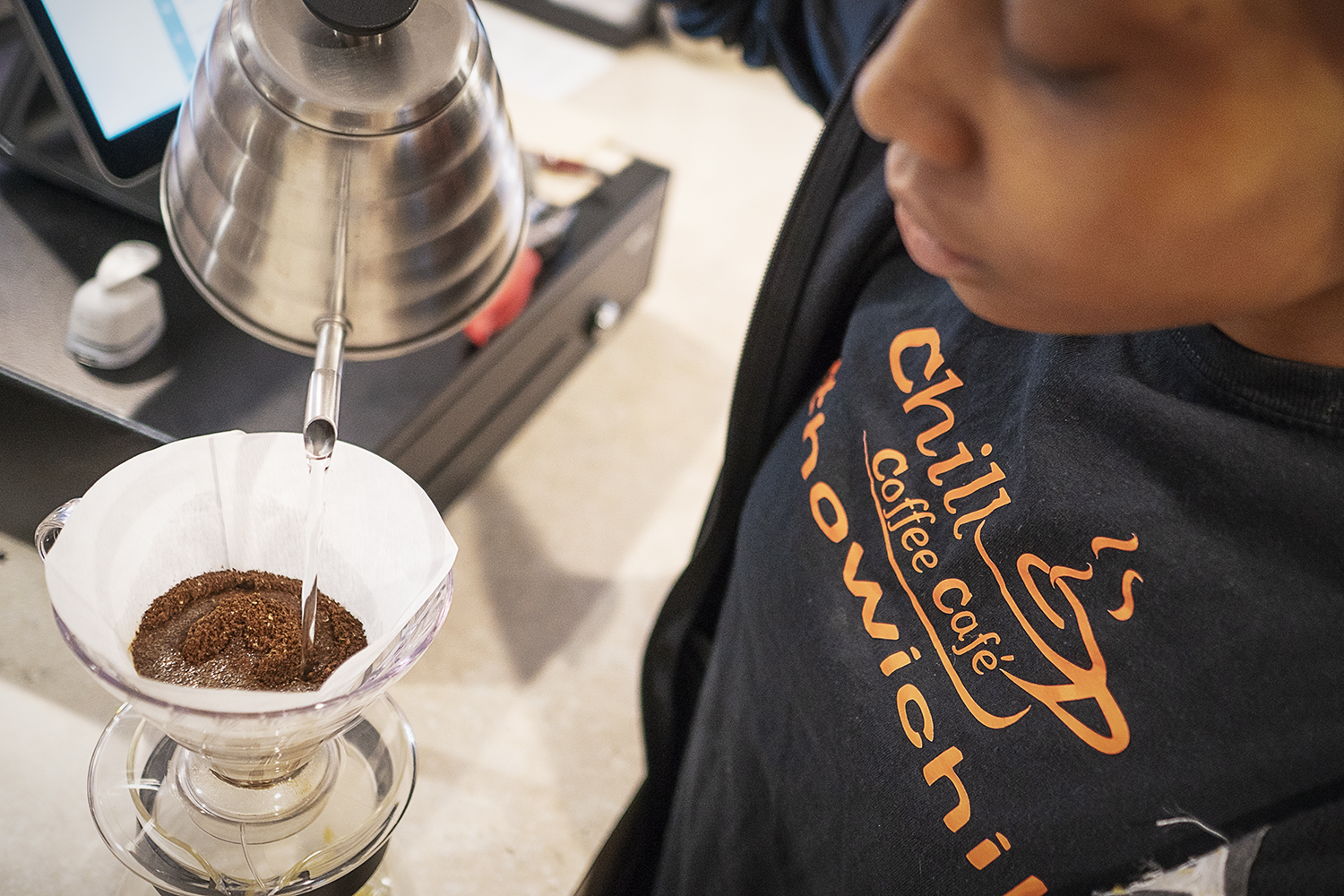 Flint, MI - Friday, June 15, 2018: Barista Cha'Quia Jones, 20, from Flint, prepares a cup of pour over coffee at Chill Coffee Cafe.