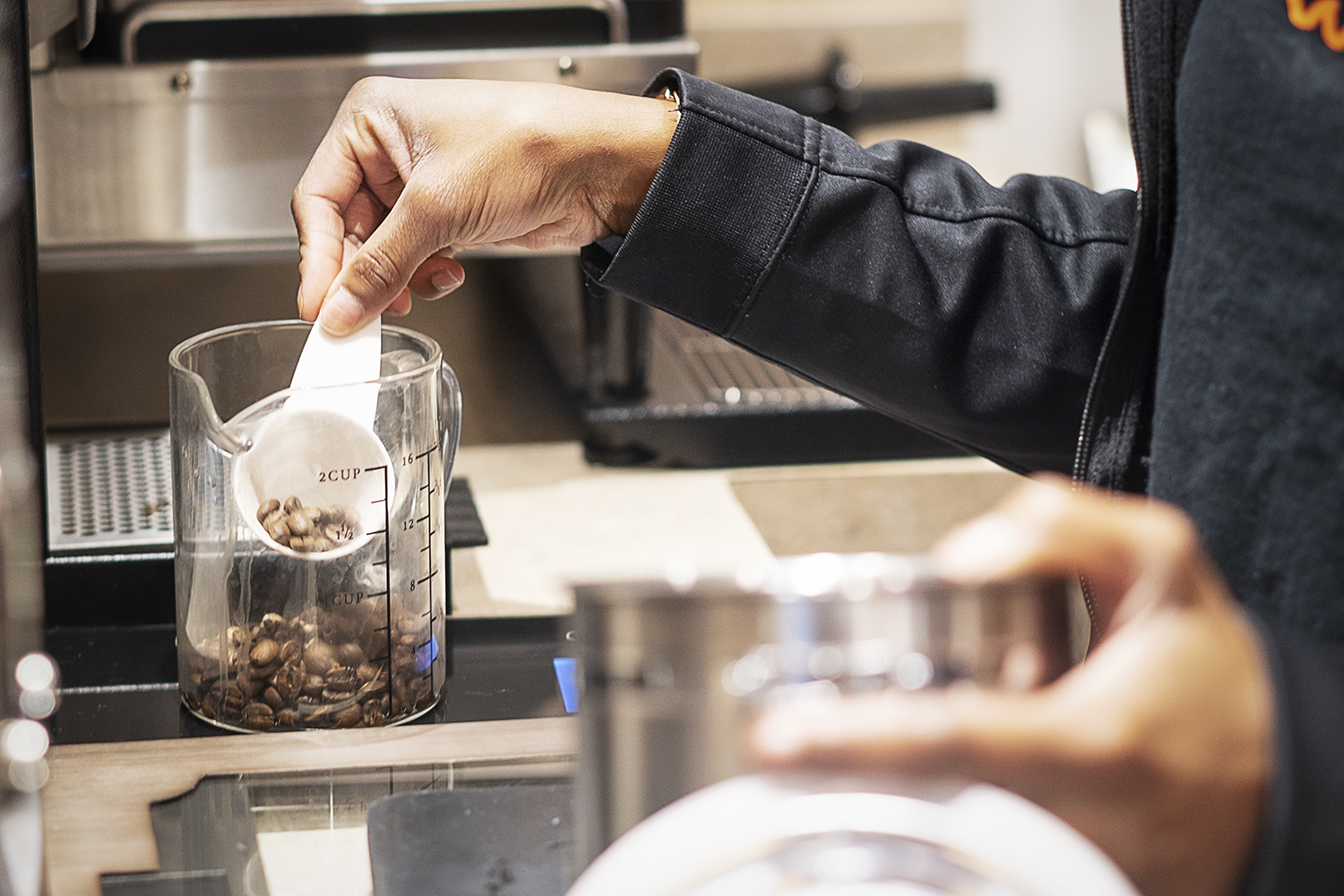 Flint, MI - Friday, June 15, 2018: Barista Cha'Quia Jones, 20, from Flint measures coffee beans for a drink at Chill Coffee Cafe.