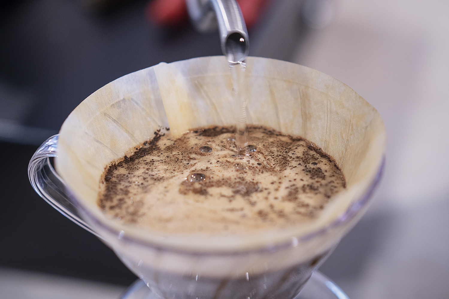 Flint, MI - Friday, June 15, 2018: Hot water is poured over freshly ground coffee beans at Chill Coffee Cafe.