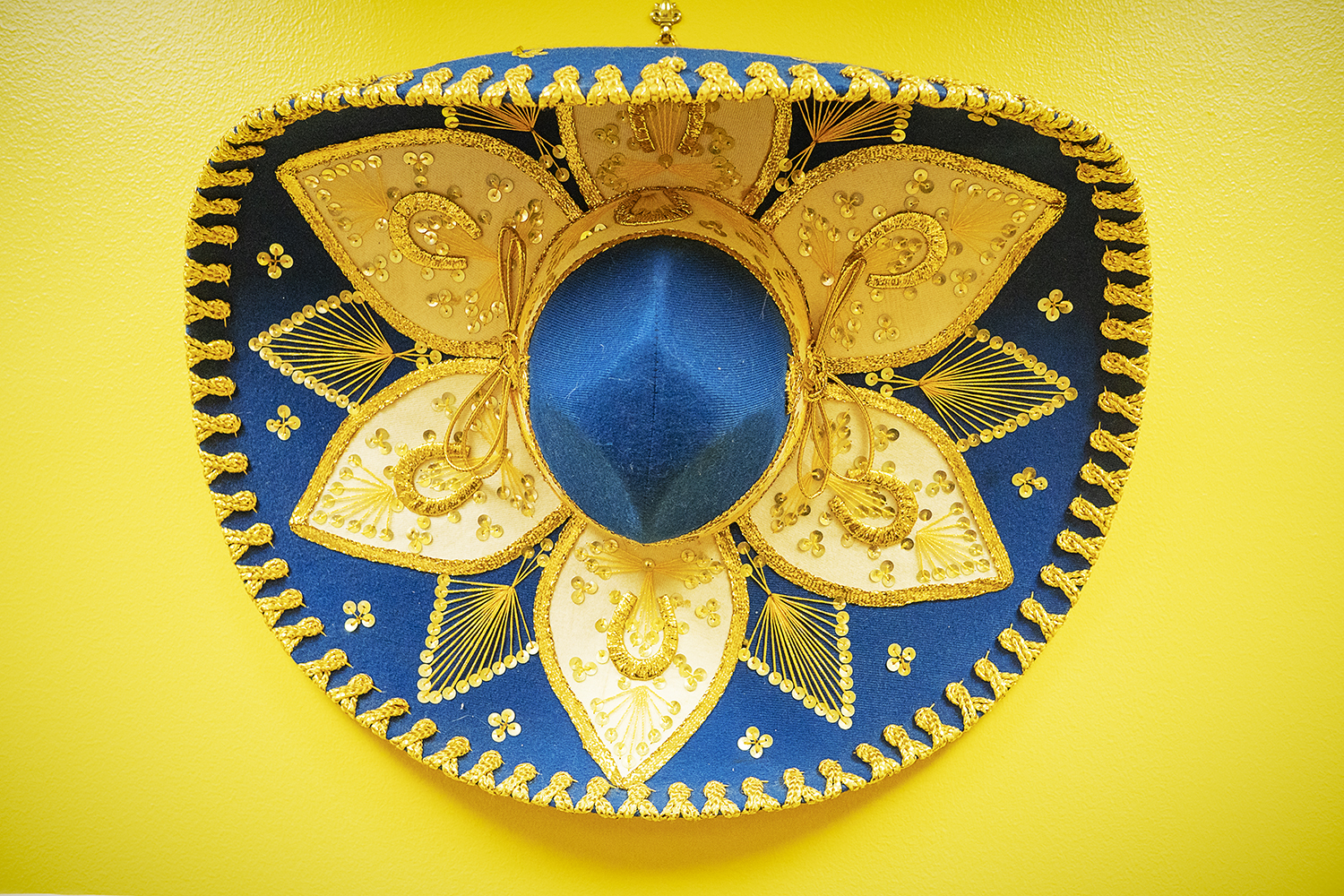 Flint, MI - Tuesday, June 19, 2018: A blue and maize sombrero hangs on the wall of the technology lab at the Hispanic Technology and Community Center of Flint.