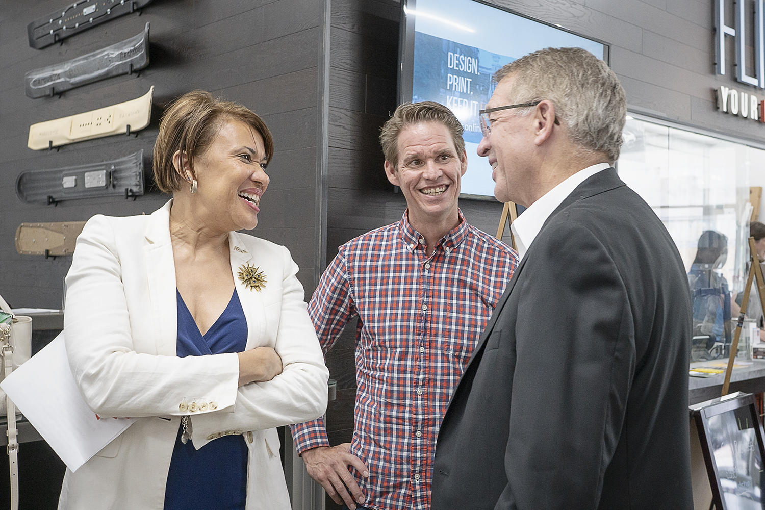 Flint, MI - Thursday, June 22, 2018: Flint Mayor Karen Weaver (left) speaks with Skypoint Ventures chief innovation officer David Ollila (center) and founder Phil Hagerman (right) at The Ferris Wheel in Downtown Flint before the official move-in part