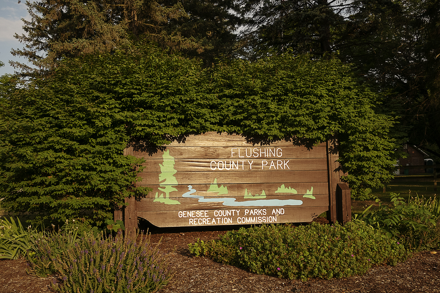 Flushing, MI - Monday, July 16, 2018: The morning sun illuminates the sign out front at the Flushing County Park.