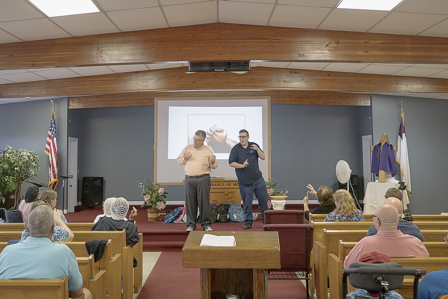 Pastor John Bienlein (left) and Austin Rupert lead worship at Master's House Deaf Church in Flint.