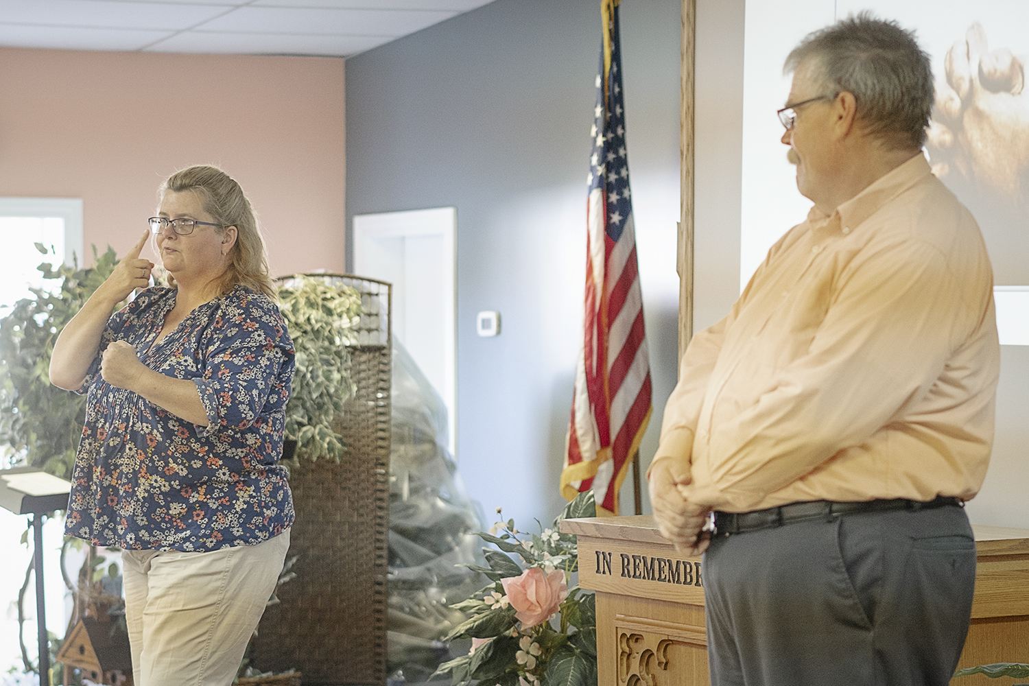 Pastor John Bienlein watches as Kirstan Loghry addresses the congregation at Master's House.