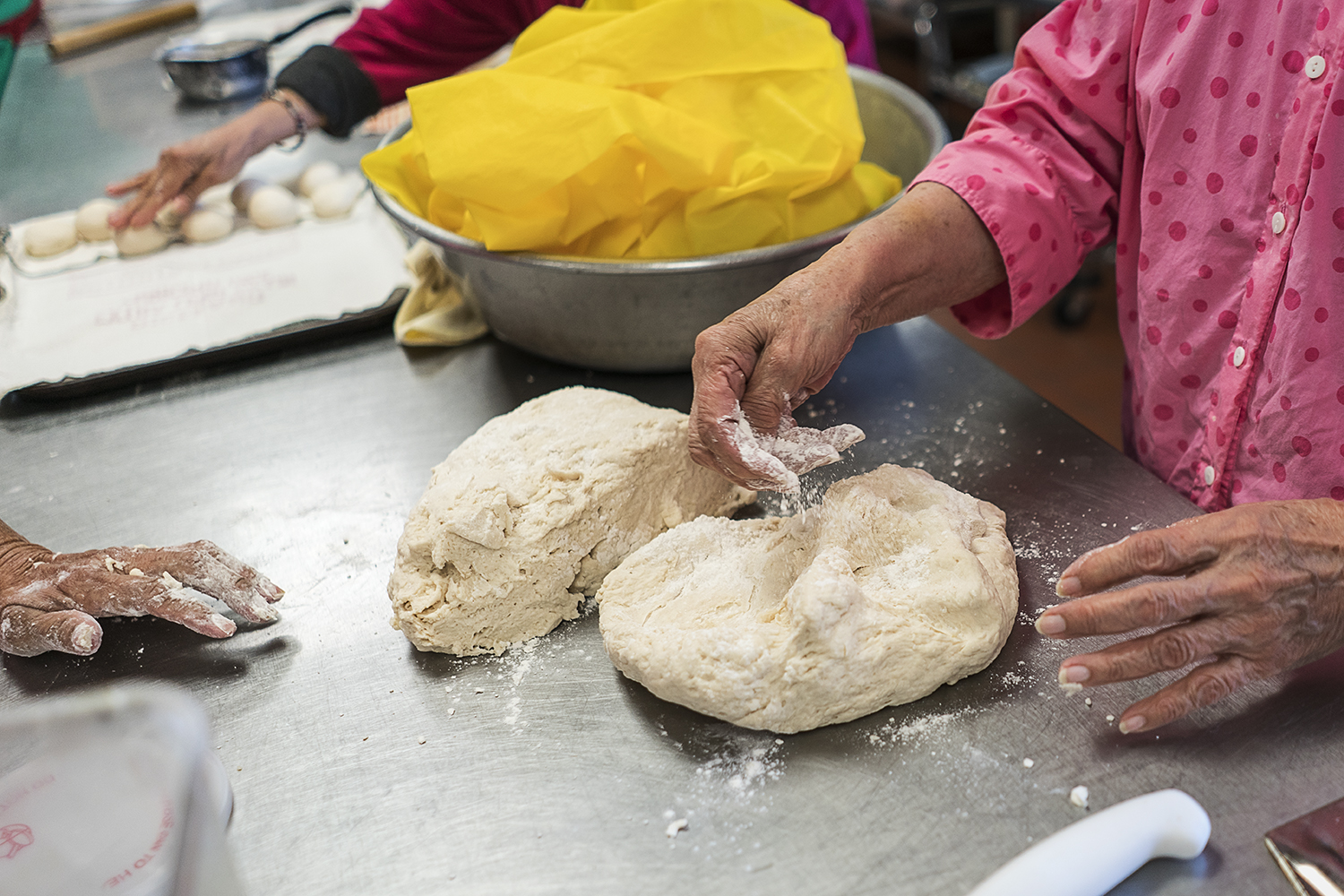 The women of the Tortilla Factory each bring their own unique style of handling the masa. Some sprinkle flour, some dip the masa in flour, and some sprinkle flour on the countertops as they prepare tortillas for Our Lady of Guadalupe.