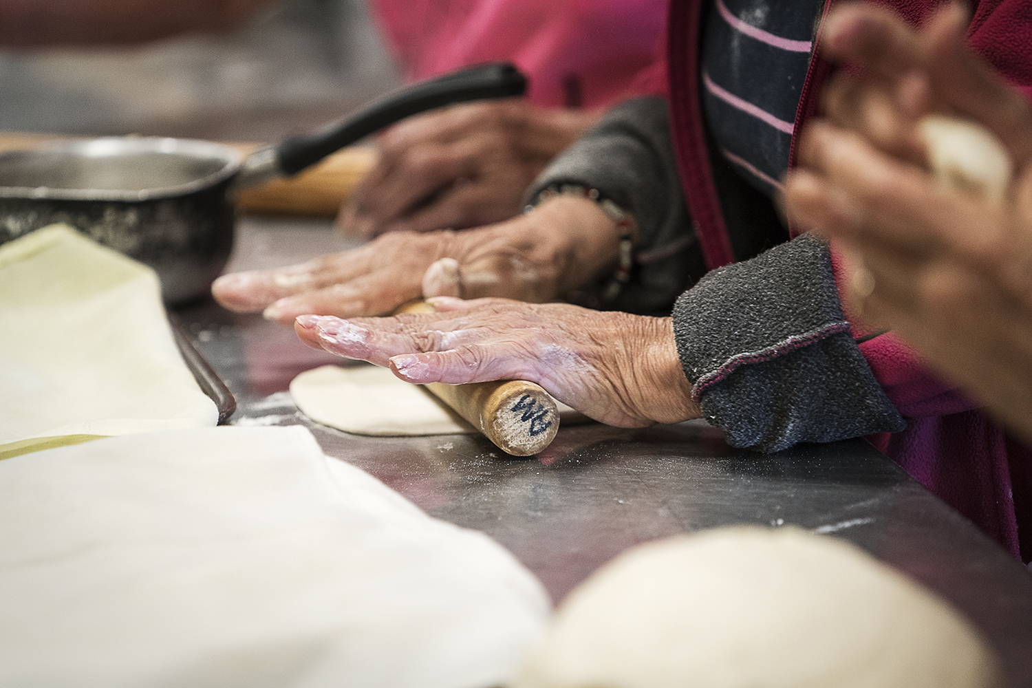 The ladies of The Tortilla Factory take positions along their assembly line in the kitchen of the San Juan Diego Activity Center at Our Lady of Guadalupe Catholic Church.