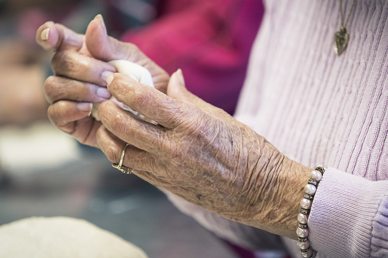 Linda Quintanilla, 90, from Flushing, forms small balls of masa. 