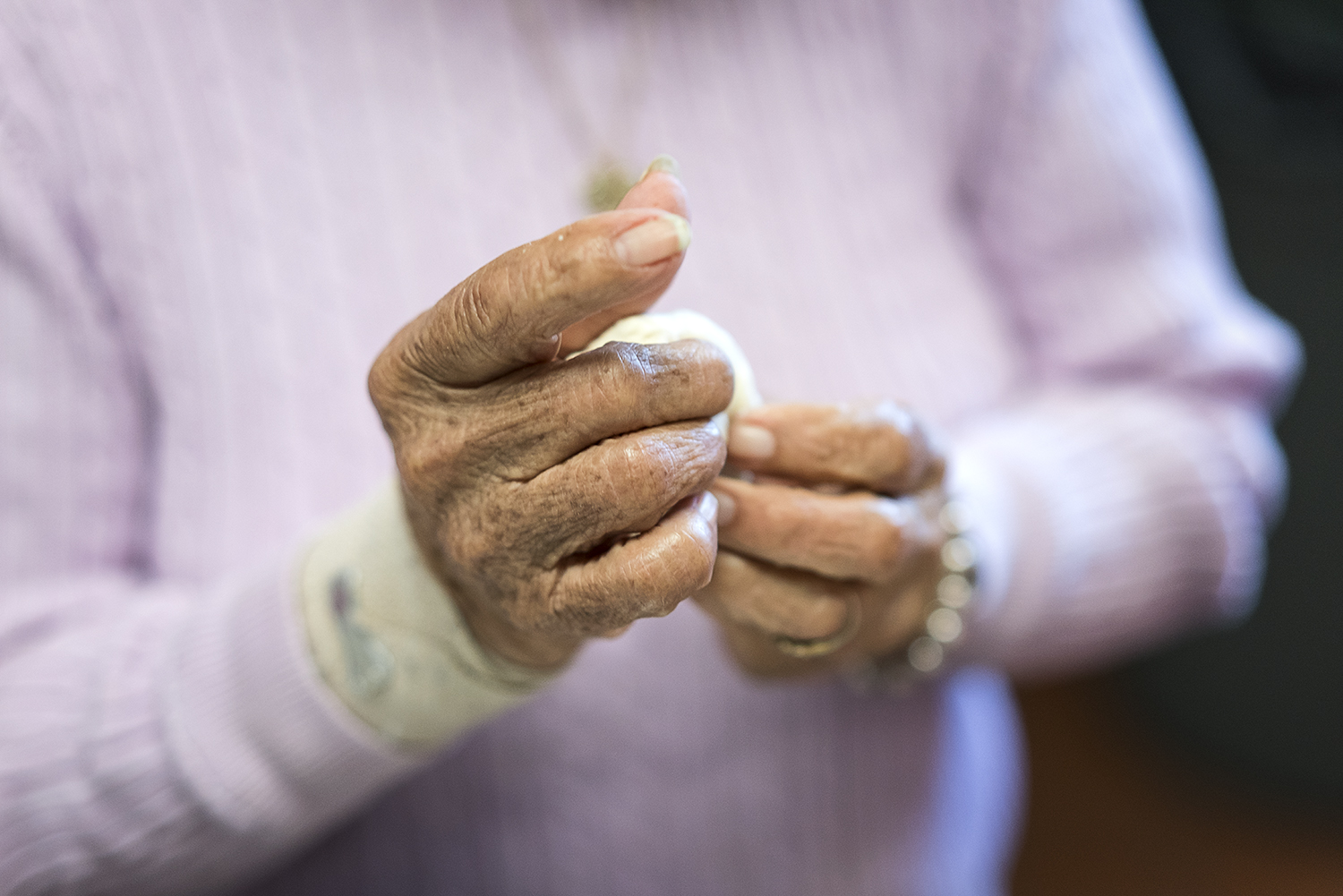 Linda Quintanilla, 90, from Flushing, forms small balls of masa.