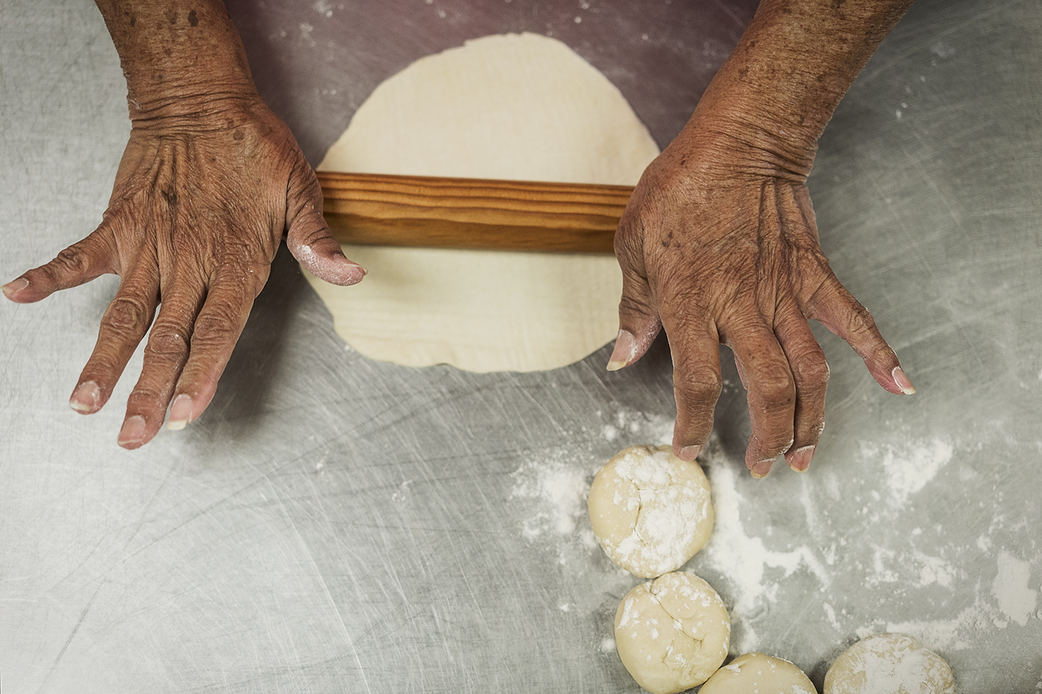 Ofelia Luna, 79, of Flint, rolls out masa to make tortillas, a weekly tradition at Our Lady of Guadalupe Catholic Church.