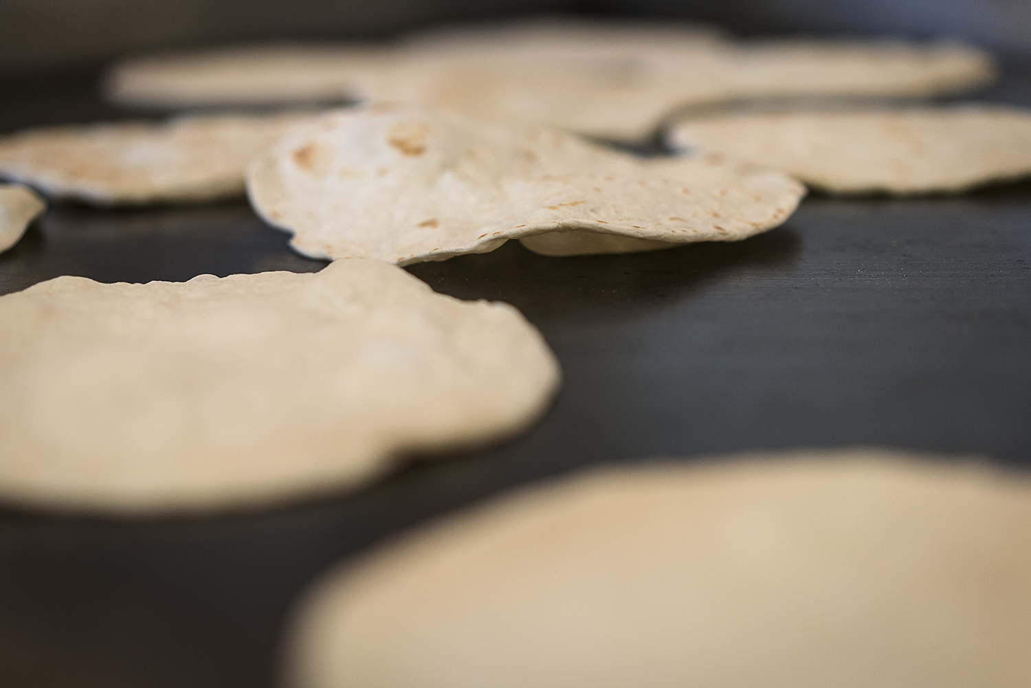Homemade flour tortillas bubble and brown on the cooktop in the kitchen at the San Juan Diego Activity Center at Our Lady of Guadalupe Catholic Church. 