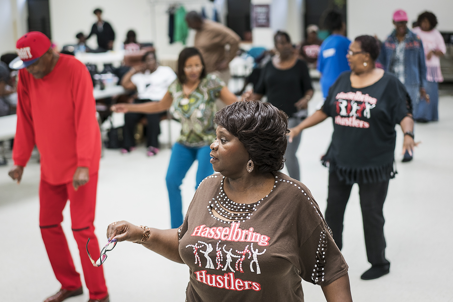Hasselbring Hustlers committee chairperson Marva Johnson of Flint (center) wears her custom Hustlers shirt as she dances. She ended up starting a class at the center to teach others how to customize their own shirts.