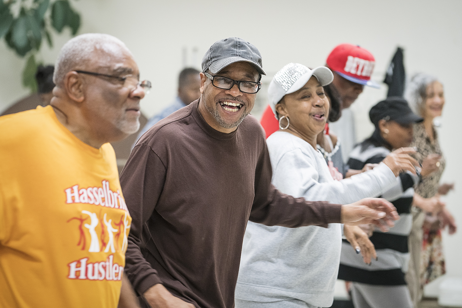 Gardell Haralson, 64 (center left) laughs as he dances with the Hasselbring Hustlers at the Hasselbring Senior Community Center. Haralson helped grow the Hustlers from a meager 15 participants to approximately 150 over the past four years.