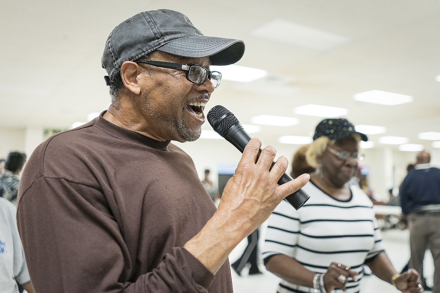 Gardell Haralson, 64, from Flint, calls out steps as the Hustlers dance at the Hasselbring Senior Community Center. Haralson earns little money from the two classes he teaches each week, insisting the money go to the center for improvements. "Some pe