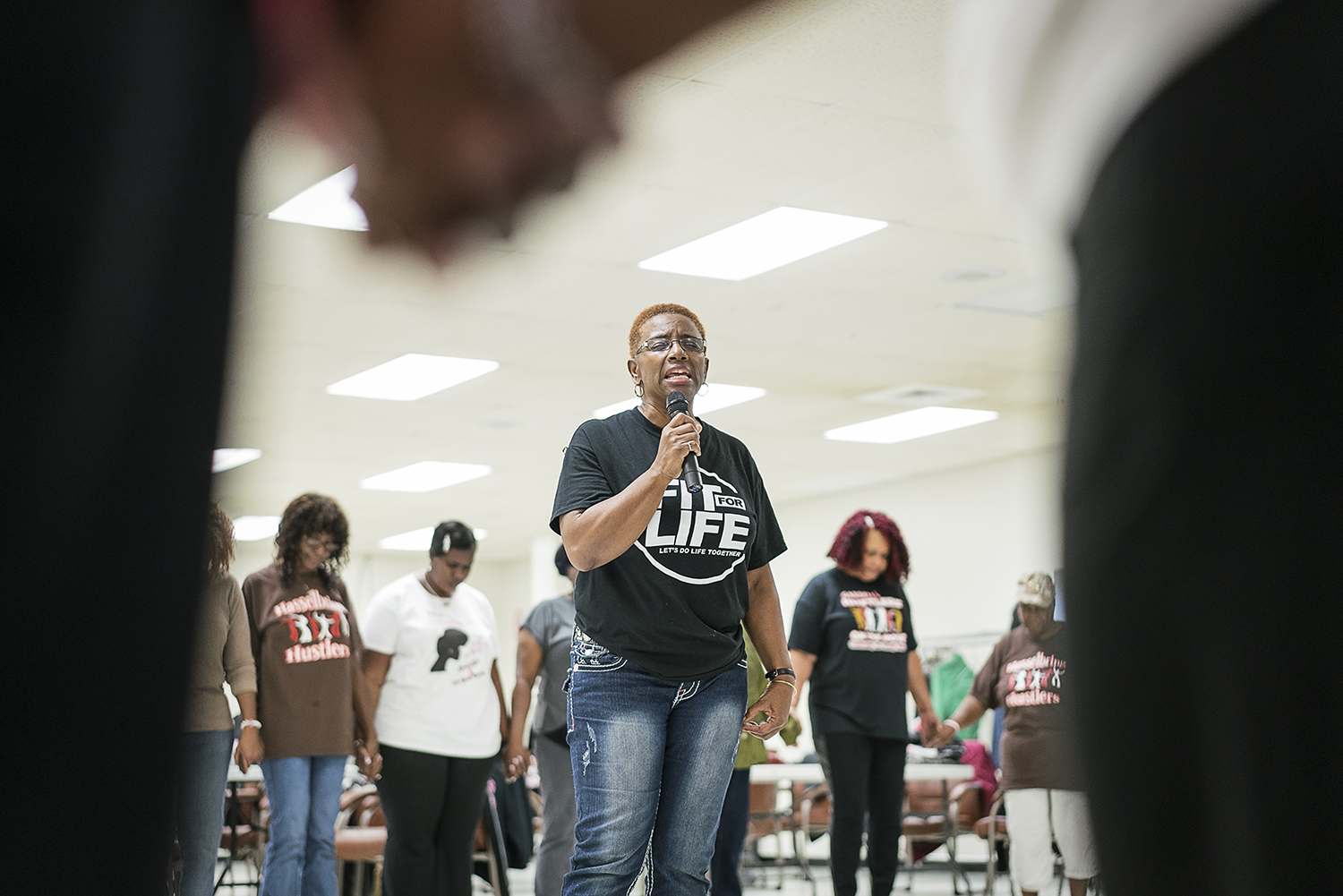 Queenella McGee, 66, of Flint leads the Hasselbring Hustlers in prayer before they finish their dancing for the day at the Hasselbring Senior Community Center. 