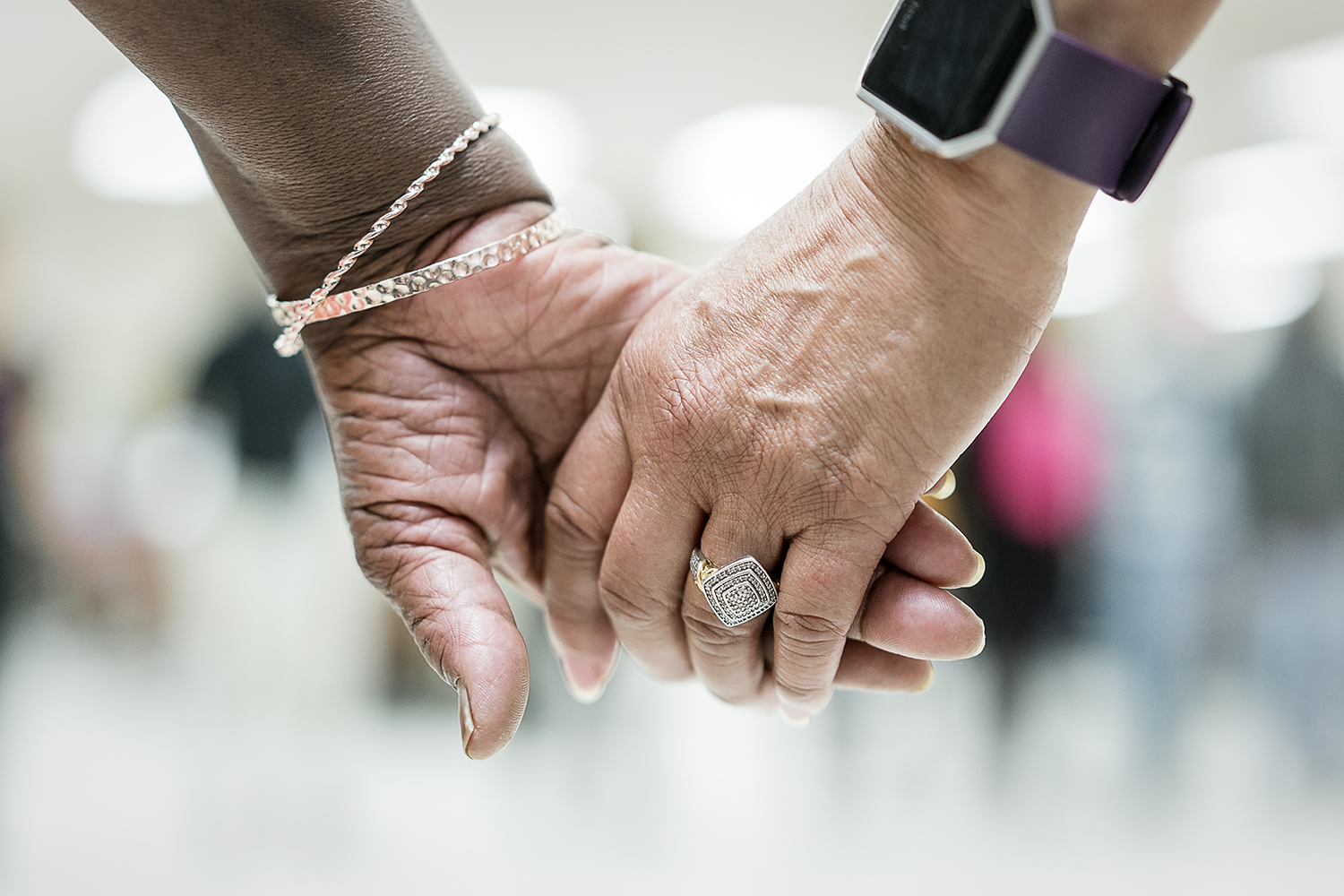 Two Hasselbring Hustlers hold hands during the closing prayer after nearly two hours of dancing at the Hasselbring Senior Community Center.