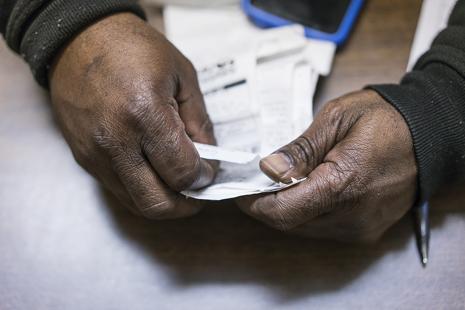 Behind his desk at Asbury United Methodist Church, Kevin Croom, 52, of Flint, reviews receipts for expenses associated with running water delivery trucks. Croom is in charge of coordinating and managing all of the water deliveries leaving the church,