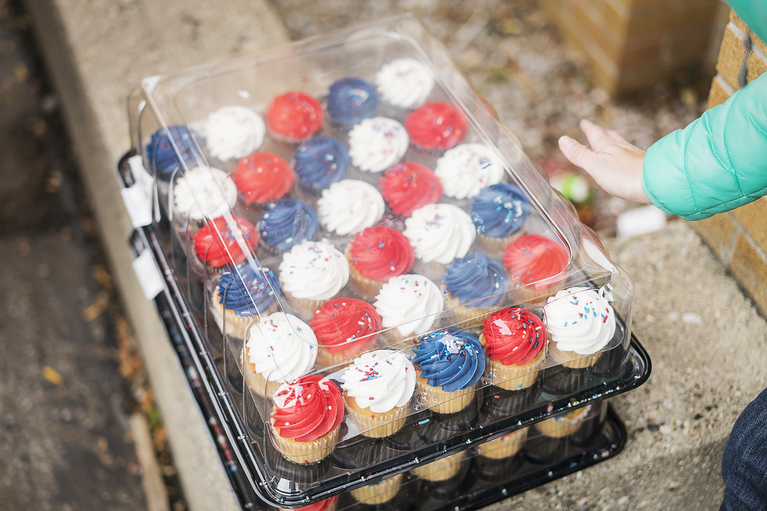 Dozens of red, white and blue cupcakes wait to be loaded onto the trailer before departing Riverside Tabernacle Church to the Flint Community Cookout. The volunteers bring various snacks and food for the community, all paid for by fundraisers hosted 