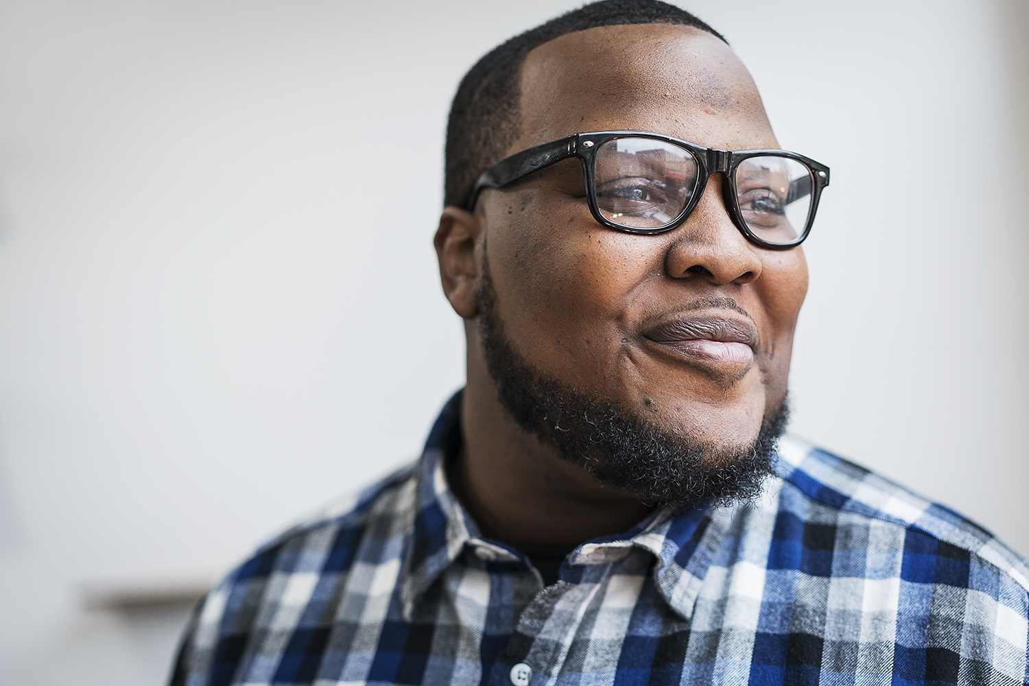 GoodBoy Clothing owner and creator Oaklin Mixon, 34, of Flint looks out onto Saginaw St. in downtown Flint from the window of his new showroom for GoodBoy Clothing. Mixon, along with 5 employees, has been preparing for the grand opening on Friday, No