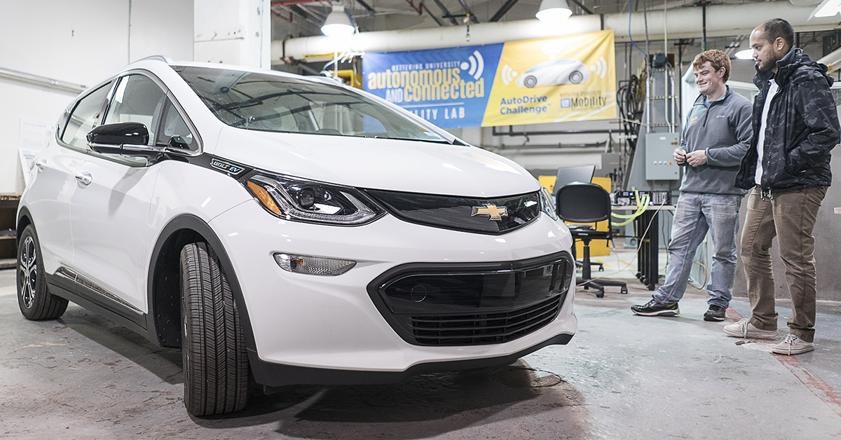 Flint, MI - Friday, November 10, 2017: Student coordinators for the SAE/GM AutoDrive Competition Alex Rath, 22 (left) and Shobit Sharma, 26, survey the new Chevrolet Bolt provided to the university for the competition in the garage at Kettering Unive