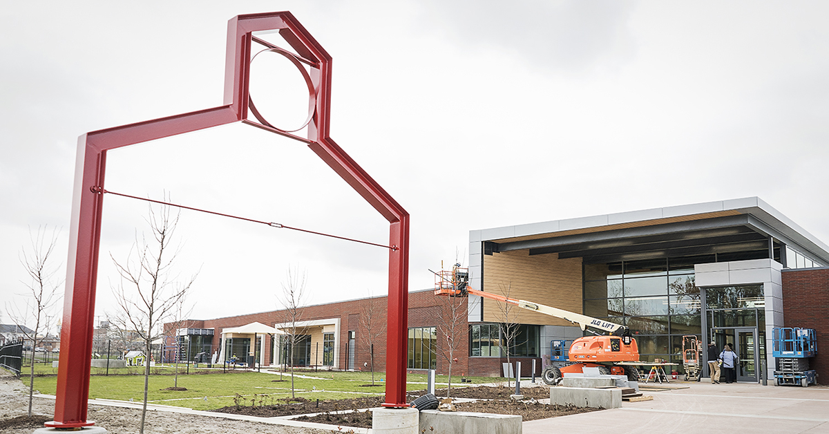 Flint, MI - Tuesday, November 21, 2017: Workers put the finishing touches on the entryway of the new Educare Center in Flint.
