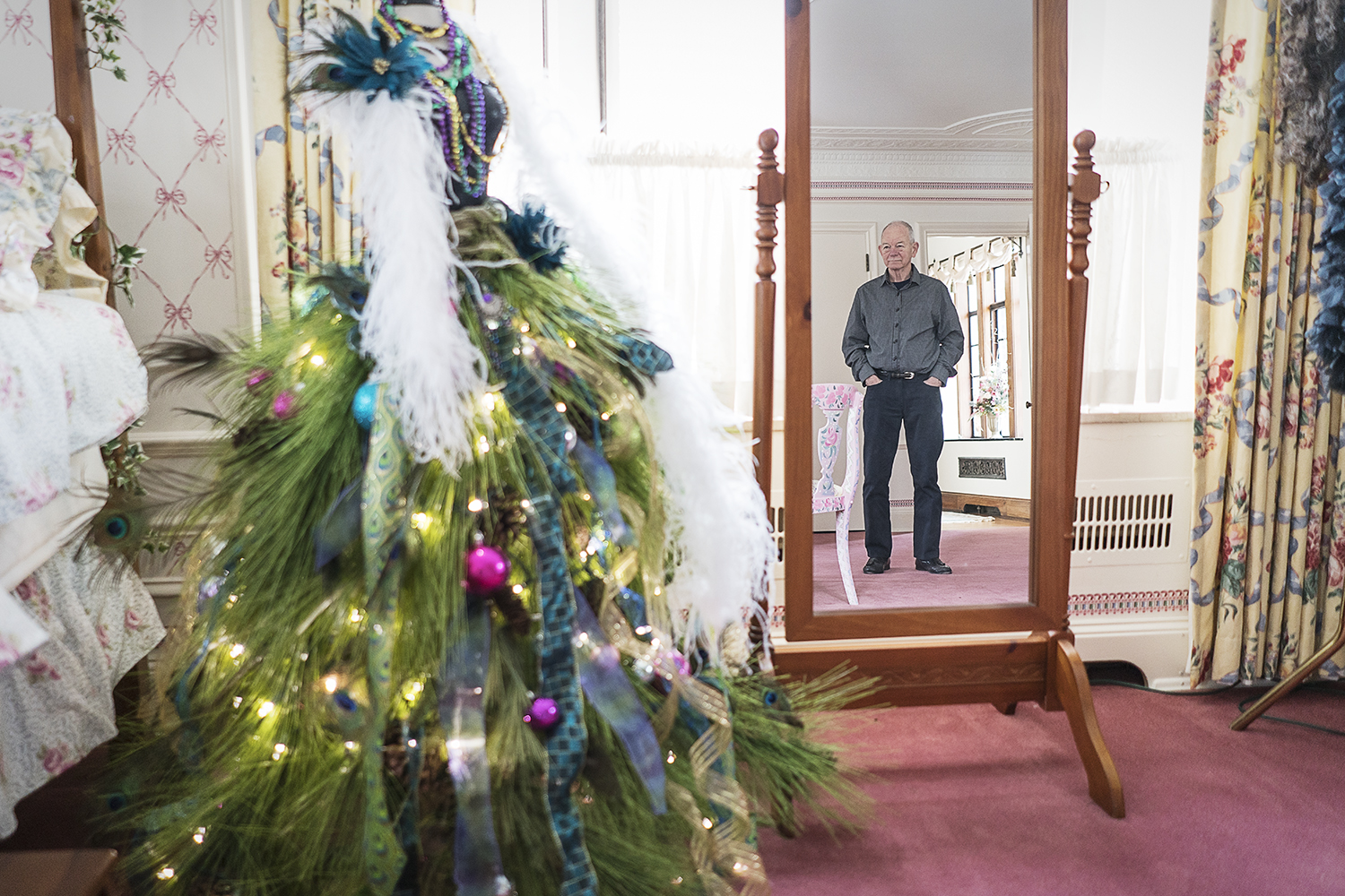Steve Heddy looks at a Christmas tree he and his wife Rosanne created from a mannequin bodice in their home.