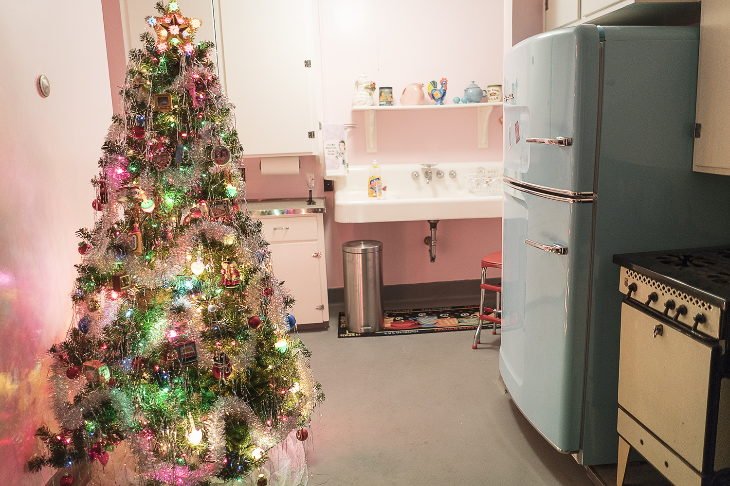 "The Lucy Tree" is brightly colored and adorned with silver tinsel in the 1950's themed kitchen in the basement of the Heddy home.
