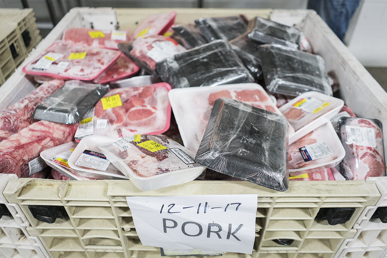 Packages of frozen pork wait to be divvied up and prepared for delivery to affiliate agencies at the Food Bank of Eastern Michigan.