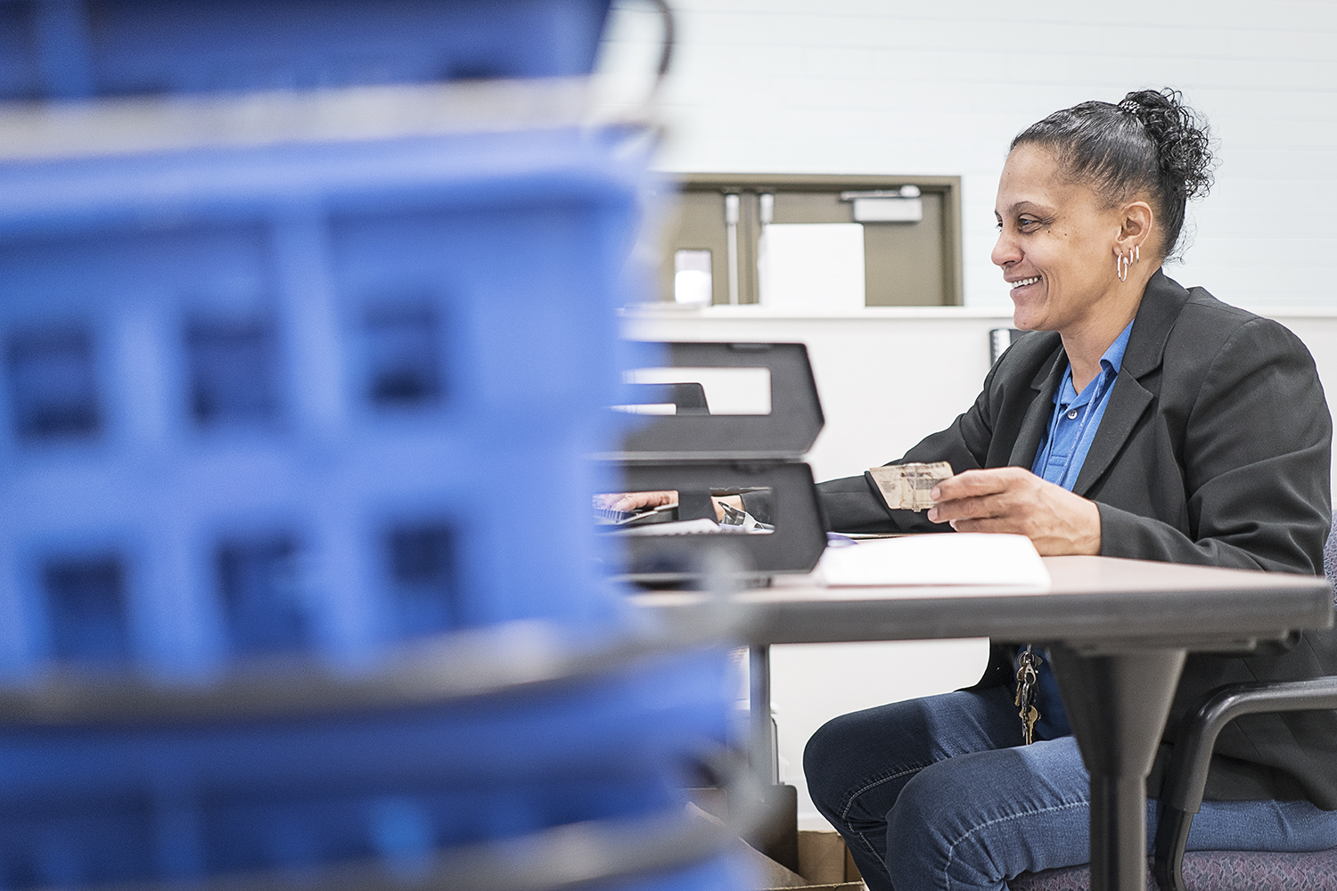 Catholic Charities Community Closet Coordinator Redonna Riggs, 47, of Flint, smiles as she assists a client. Riggs, formerly a client, works part time at the Community Closet and fills in the rest of her week as a volunteer.