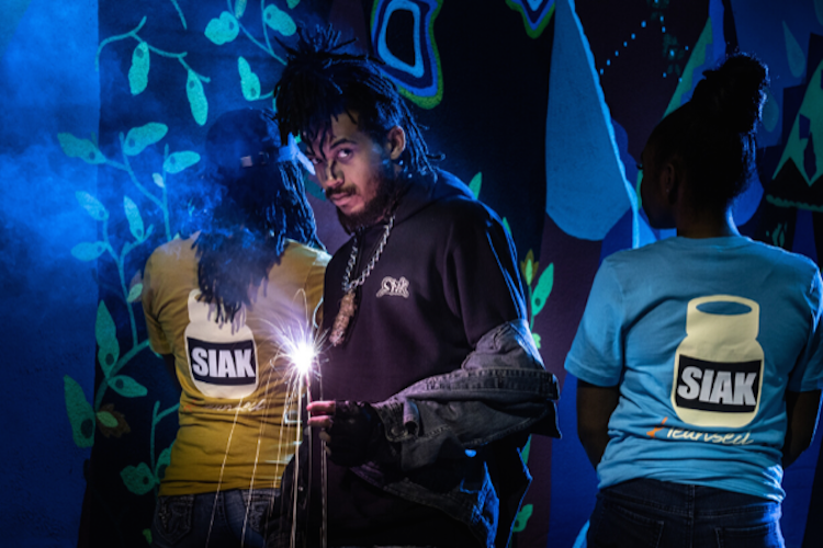 Vantrell Erving poses with models for his SIAK clothing brand. SIAK The Brand has been featured in fashion shows and collaborations since 2018.