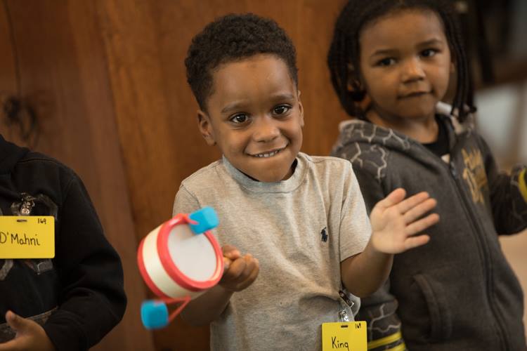 Students at Educare Flint sing, "The Ants Go Marching" during the grand opening celebration Monday, Dec. 11, 2017. 