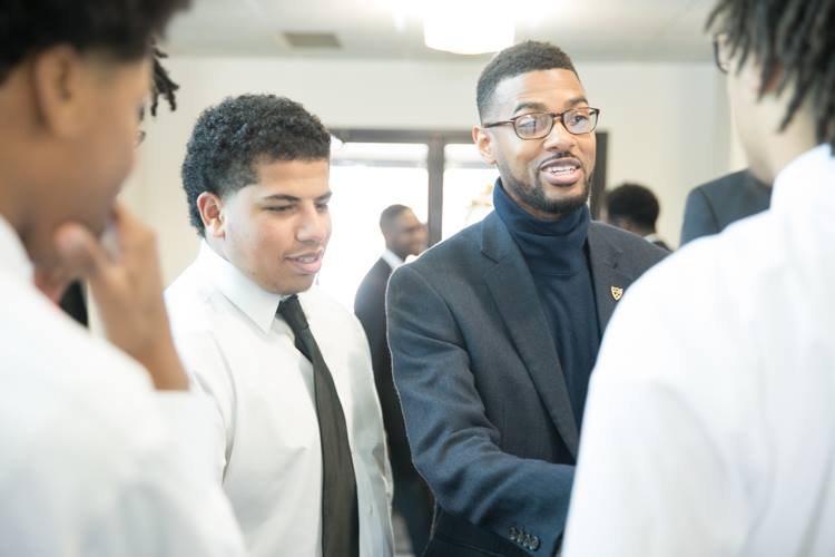 Isaiah Oliver gives last minute encouragement to the young men of the Alpha Esquires before their Martin Luther King Day performance. 