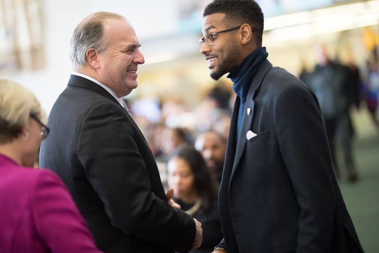 Isaiah Oliver, president of the Community Foundation of Greater Flint, greets U.S. Rep. Dan Kildee at MLK Day celebration at the Flint Public Library. 