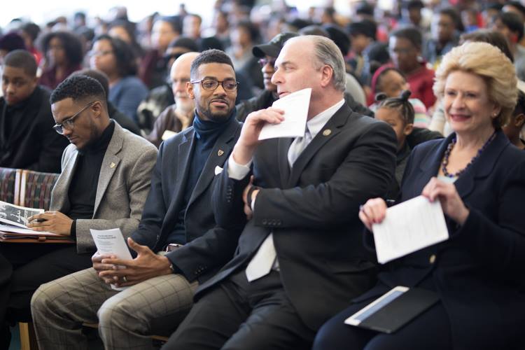 Isaiah Oliver sits along side U.S. Rep. Dan Kildee and U.S. Sen. Debbie Stabenow at the Flint Public Library MLK Day celebration.