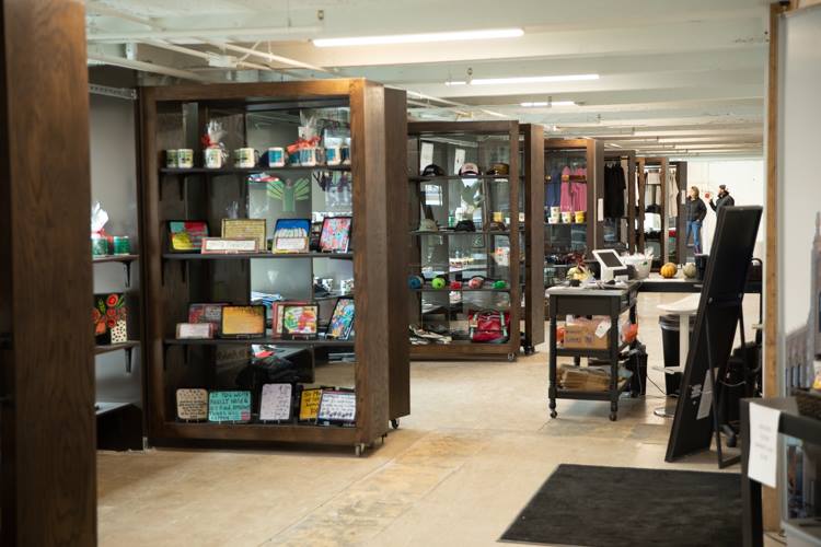 The Dryden Building Retail space sells a variety of goods including mugs, T-shirts, art, and eyeglasses from 13 vendors.