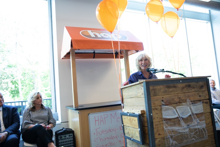 Karen Church, CEO of ELGA Credit Union, speaks at a press conference before the ribbon cutting for the Flint Farmers' Markets renovated demonstration kitchen.