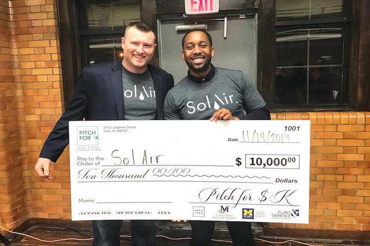 Jonathan Quarles holding his first place $10,000 win from November 2019's Pitch for $K event. 