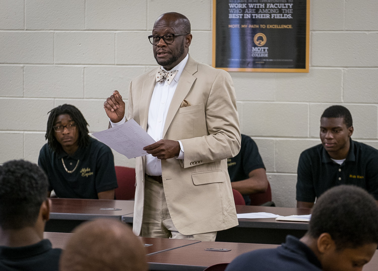 Advisor Sam Wells of Flint Township talks to the young men of the Alpha Esquires during a meeting.