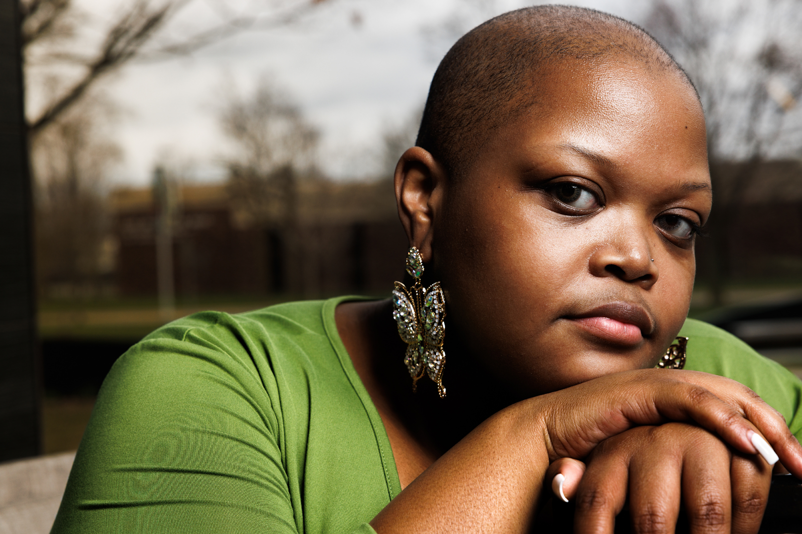 Pageant winner, poet, painter, and queer creative artist AshleyCae Lee poses dignified at the Flint Public Library on March 26, 2024. 