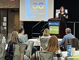 Dr. Colleen Allen, president and CEO of the Autism Alliance of Michigan, addressing the 2022 conference in Grand Rapids.