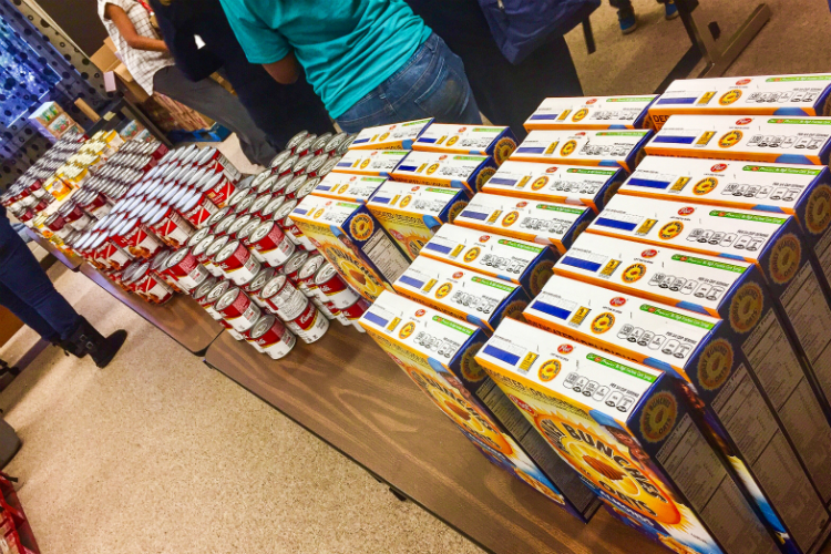 An assembly line is set up to pack the hundreds of backpacks at Holmes STEM Academy.