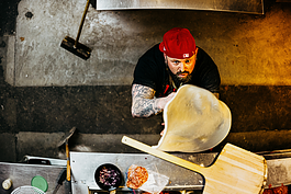 Bada Bing Pizzeria's owner and head chef Anthony Ijames pictured on Jan. 18, 2024, spinning their signature pie, Little Italy.