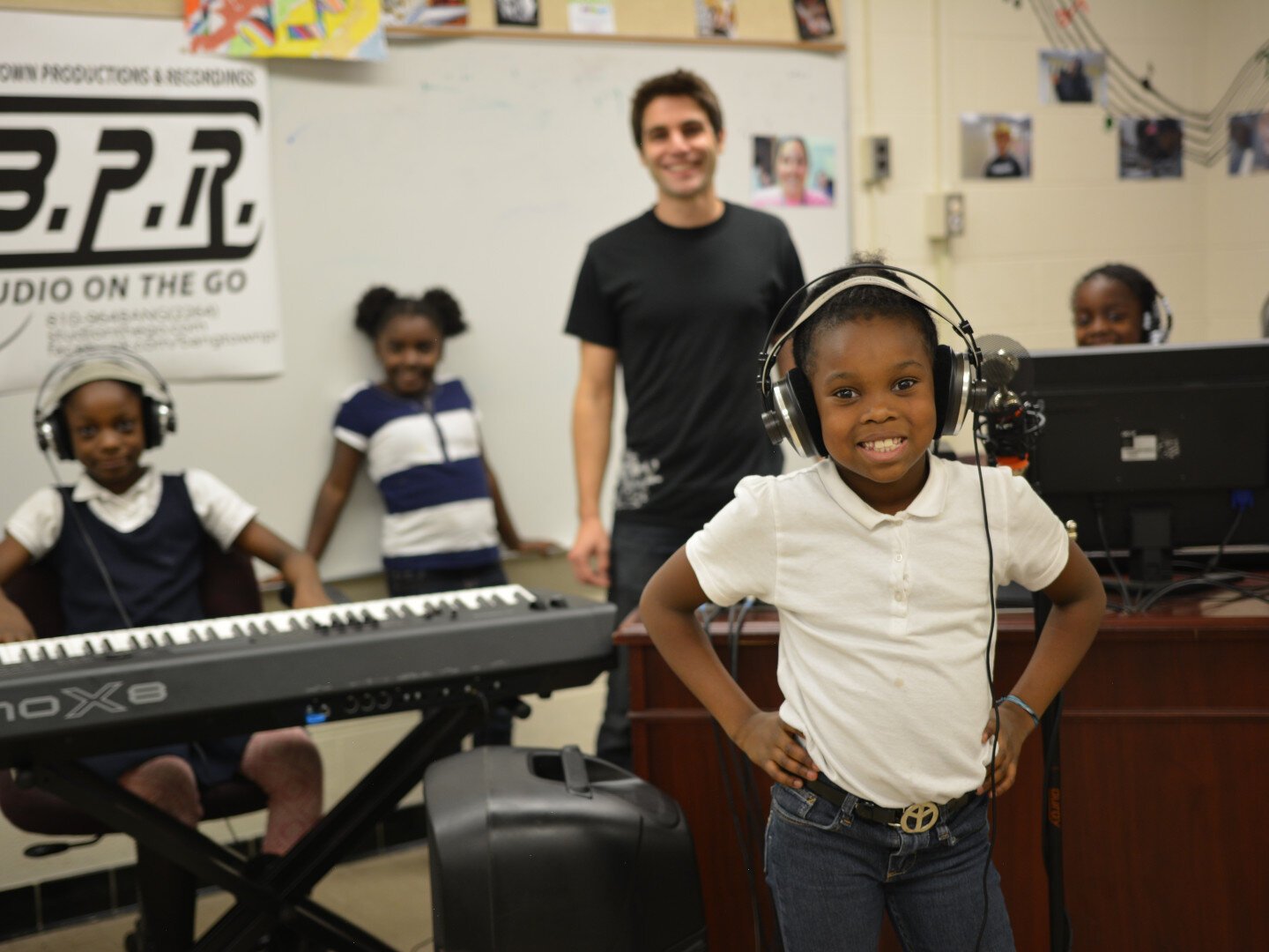 Studio on the Go is a mobile studio program that visits classrooms to teach students how to write and record their own songs, play instruments, and operate equipment.