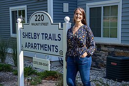 Kittie Tuinstra outside of the new Shelby Trails Apartments.
