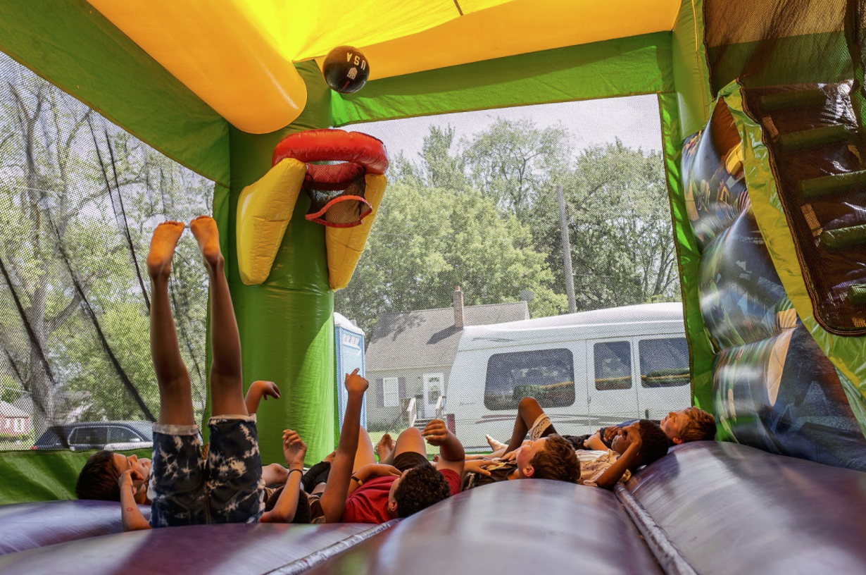 Kids play in a bounce house at Amos Park on June 5.