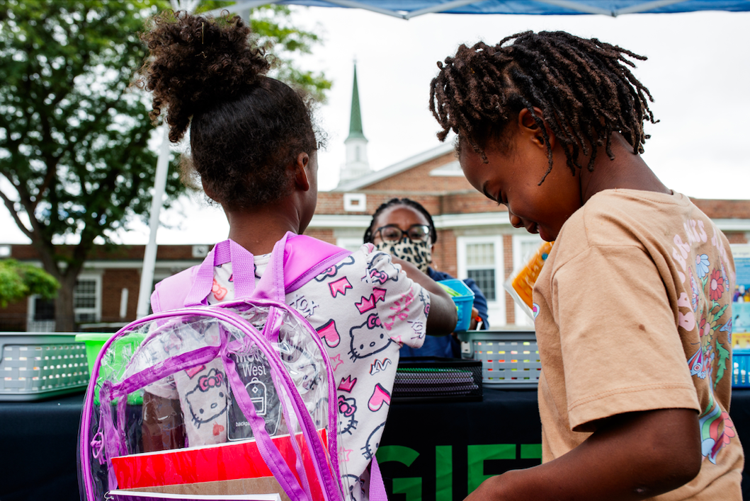 Attendants collect free school items from the Gift of Life Michigan table during the ‘Back to School Rally’ at Bethel United Methodist Church in Flint on Saturday, Sept. 9, 2023.