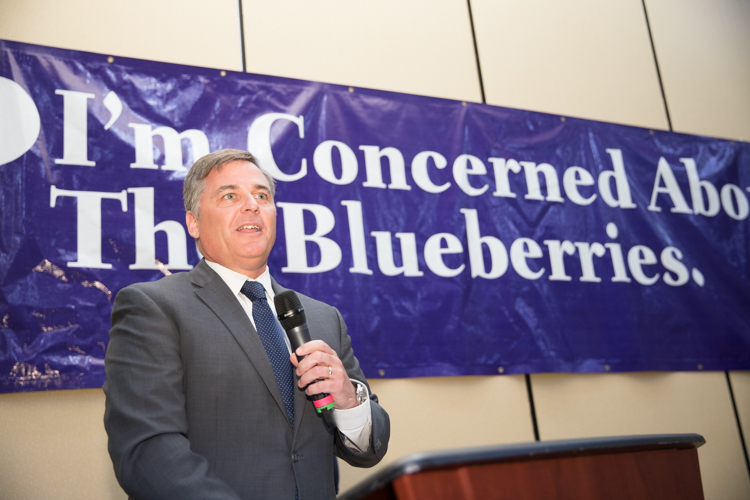 Greg Viener, Flint president of Huntington Bank, delivered a scholarship worth $3,000 to support the Blueberry Ambassador program.