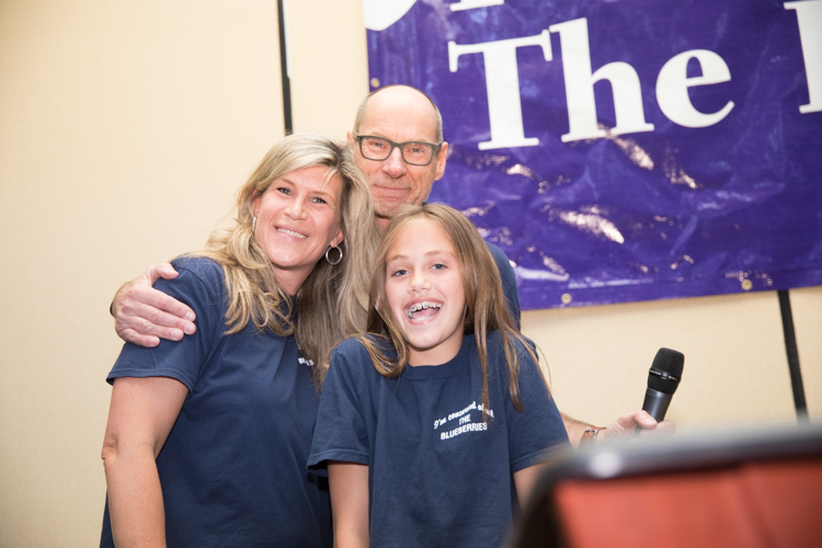 Blueberry Founder Phil Shaltz congratulates teacher Kristie Philpott and fifth-grader Katie Roti, who won the Founder's Award.