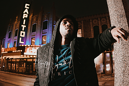 Award-winning actor and content creator Brandon Houston poses in front of the Capitol Theatre in downtown Flint on Jan. 30, 2024.