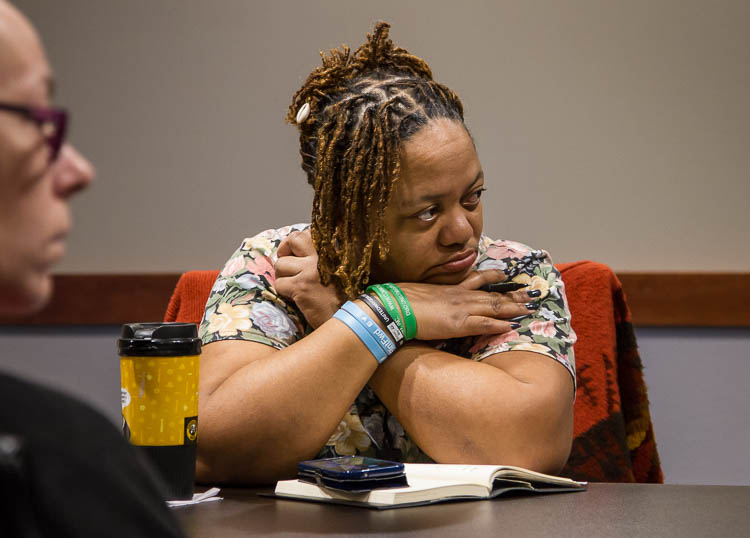 Carma Lewis listens during a meeting of Recovery Resource Group at the Food Bank of Eastern Michigan in Flint.