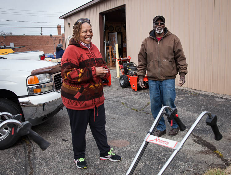 Carma Lewis visits with staff at the Community Tool Shed at the Neighborhood Engagement Hub on Martin Luther King Avenue. At right is Hurb Pitts, manager of the Community Tool Shed.